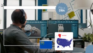 Man with earphones working on a computer US states map Nevada file a DBA