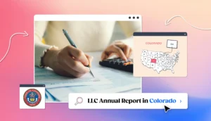 Colorado LLC annual report hands with calculator filling up a report